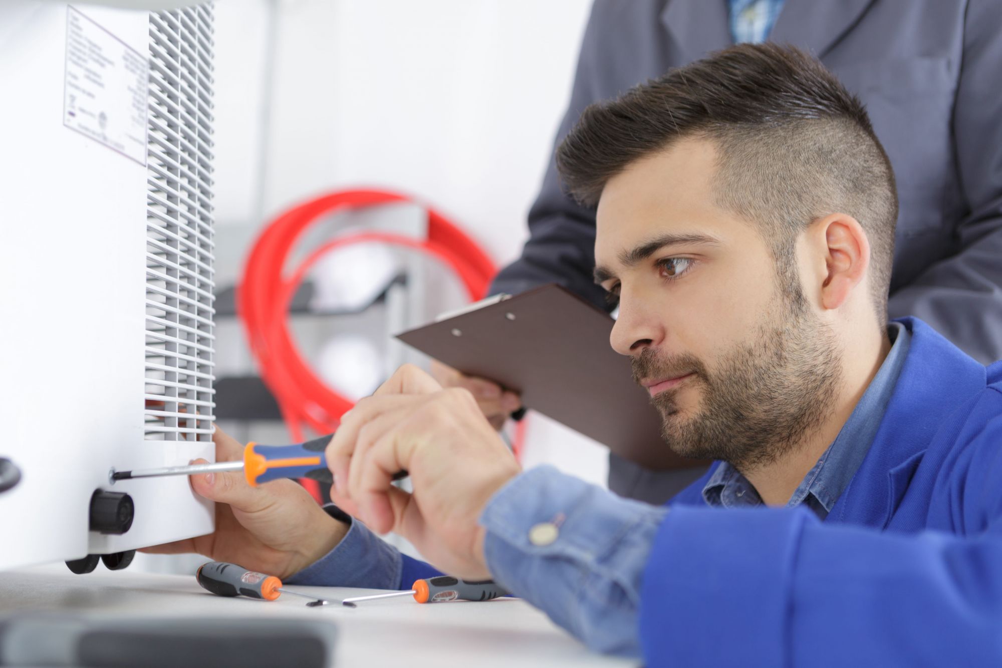 Man repairing HVAC components.